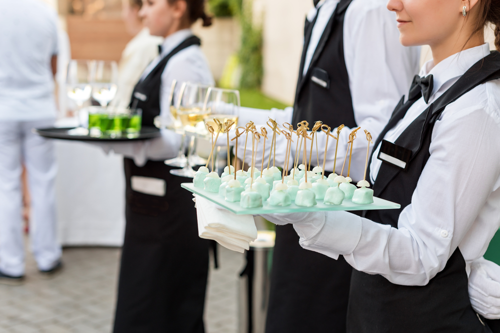 Waitresses serving wine and canapes