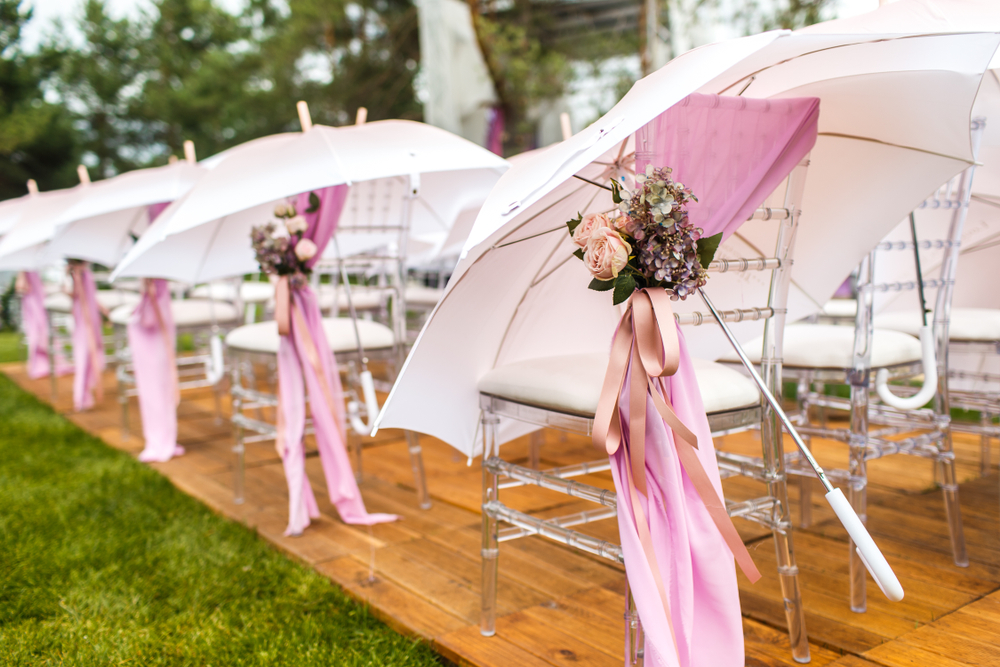 White and pink umbrellas at a wedding reception