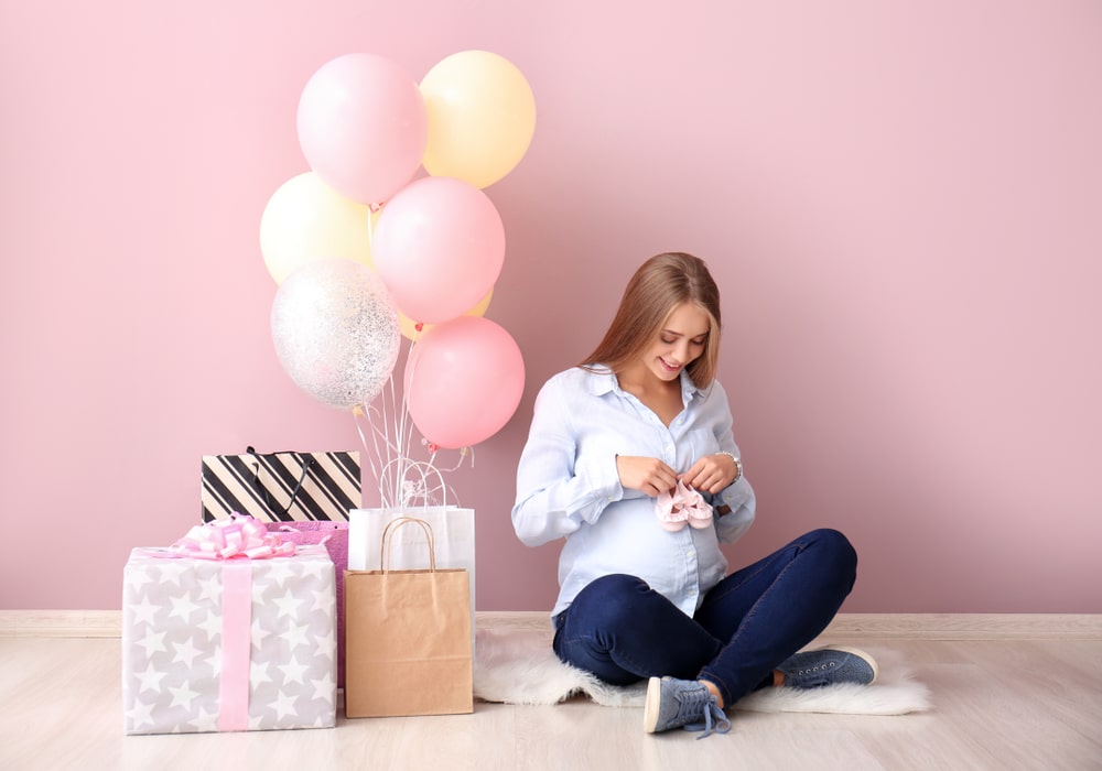 Expectant mother with baby shower gifts