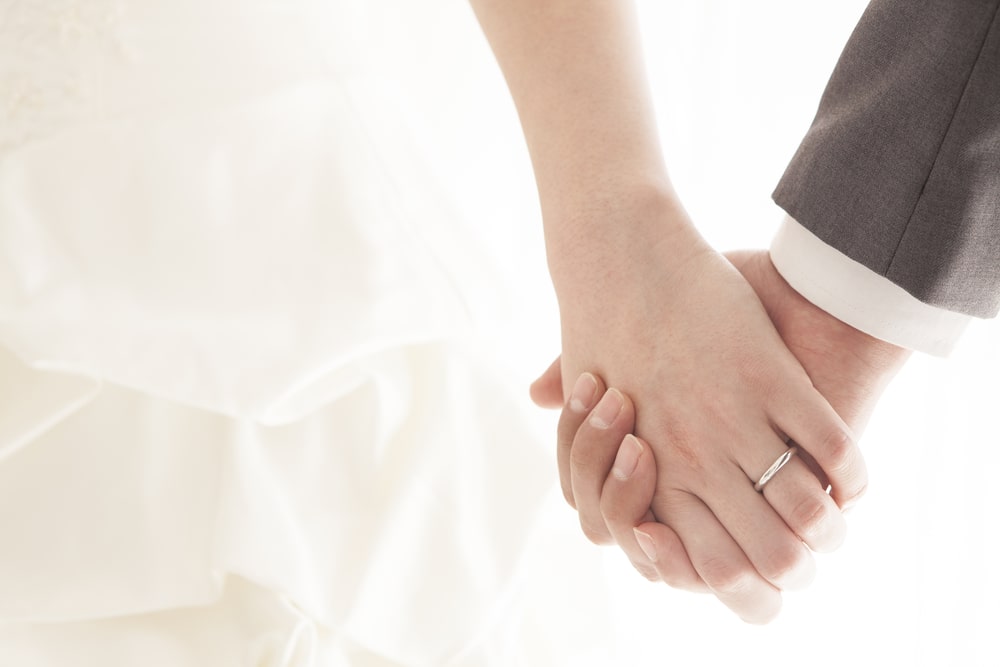 Newlywed couple holding hands