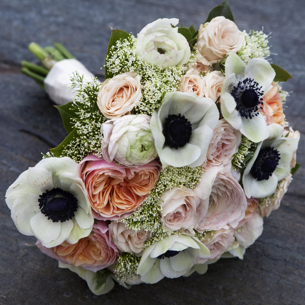 Wedding bouquet of pink roses and white anemone and pink ranunculus