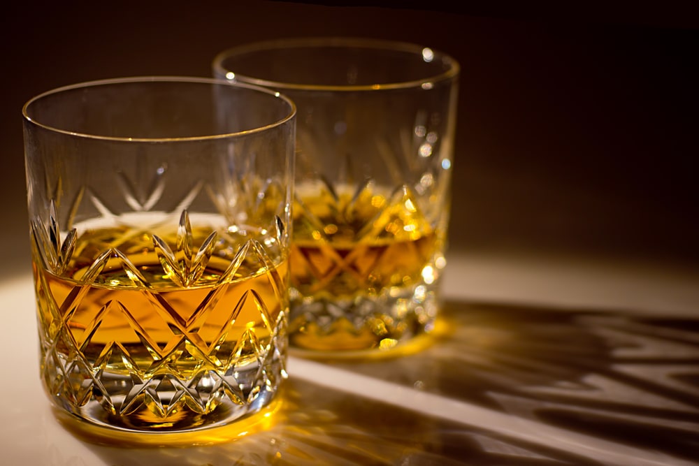 Two cut crystal whisky glasses with whisky