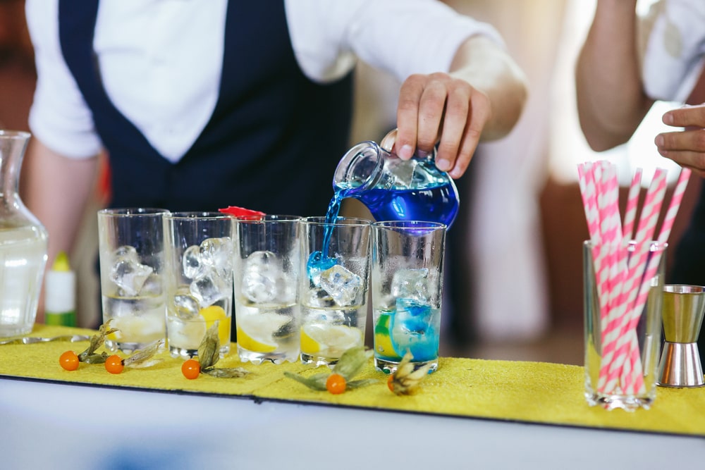 Two mixologists creating drinks and cocktails at a wedding reception