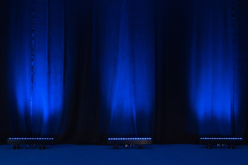Uplights in front of blue curtains