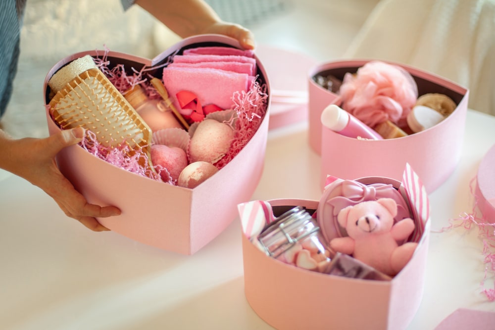 Pink colored heart shaped gift boxes of bath and body products for bridesmaids