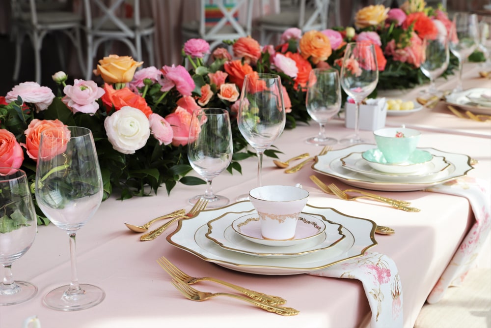 Table set up for a bridal shower vintage tea set and floral napkins