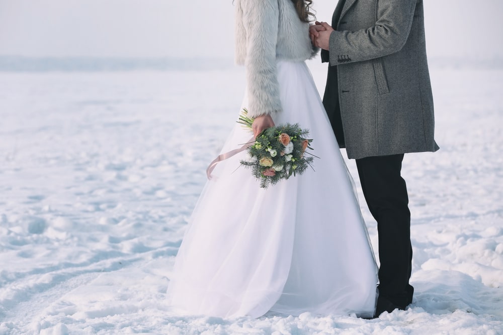 Happy wedding couple outdoors on a winter day