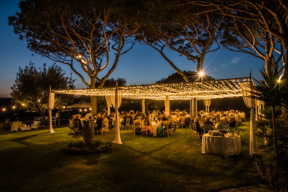Marquee lit at night in a traditional summer wedding