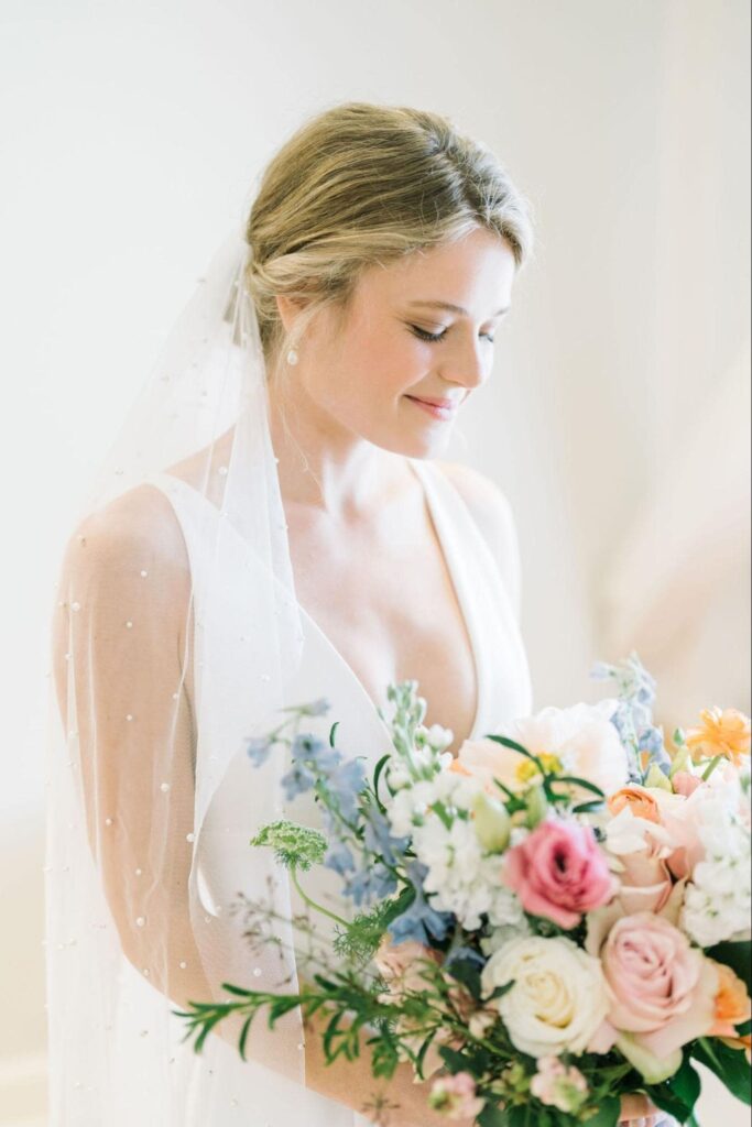 Young beautiful blonde bride with a blooming bouquet