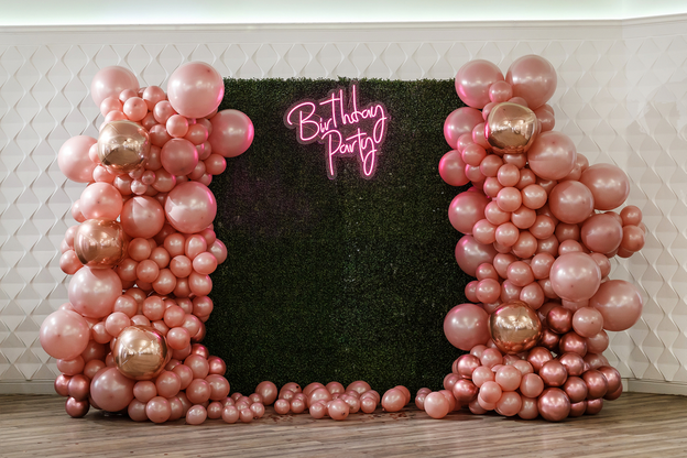 Boxwood Backdrop Wall with balloons of pink, gold, and rose gold