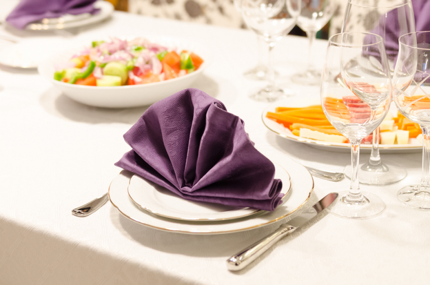 Purple fan napkin on a table set up