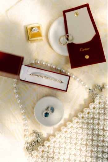 Cartier jewelry laid out on a table with a bracelet in full focus