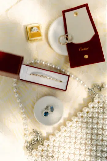 Cartier jewelry laid out on a table with a bracelet in full focus | Curated Events Cartier jewelry laid out on a table with a bracelet in full focus