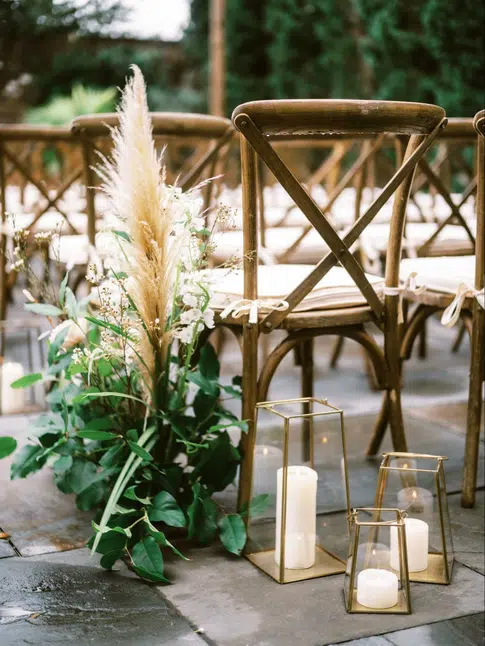 Wedding chair set up in boho style with pampas grass and greenery