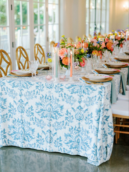 Wedding table settings with colorful flowers and dainty glass accents