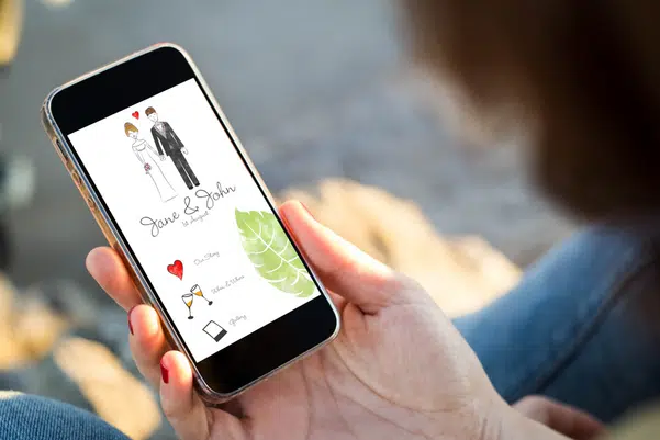 close-up view of young woman checking wedding website on her mobile phone