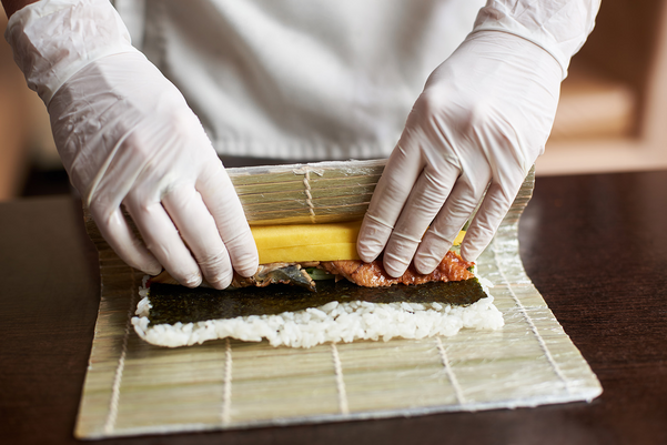 Closeup view of process of making sushi