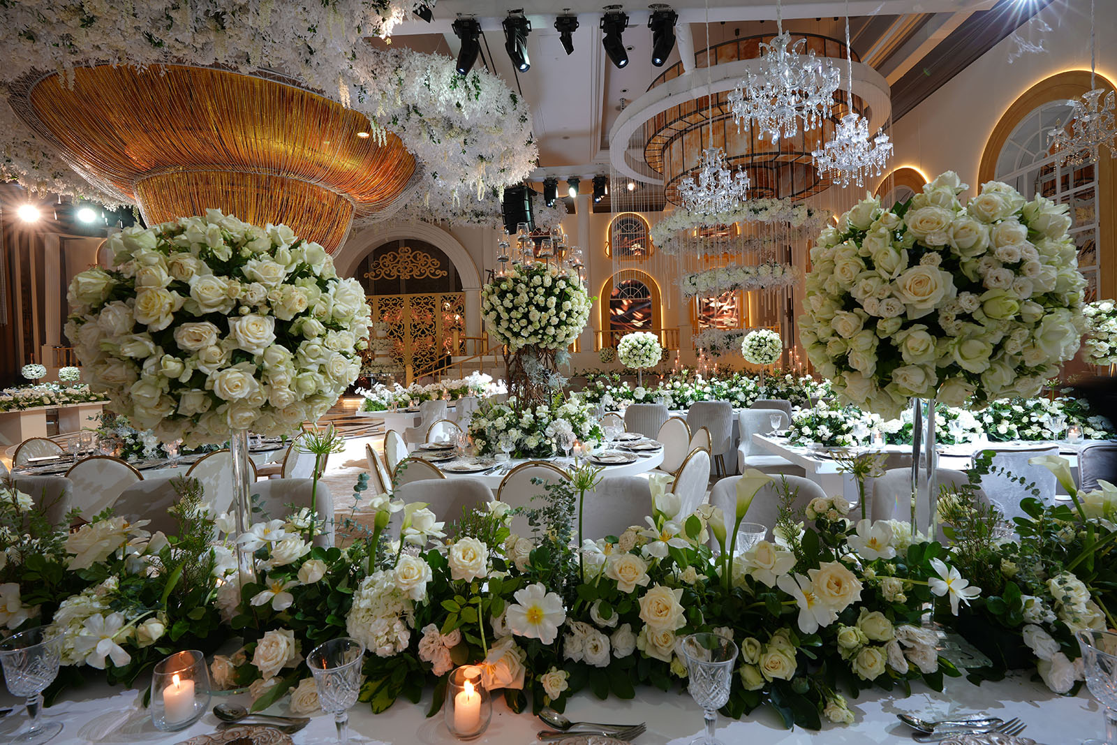 A beautiful wedding table adorned with bouquets of white roses