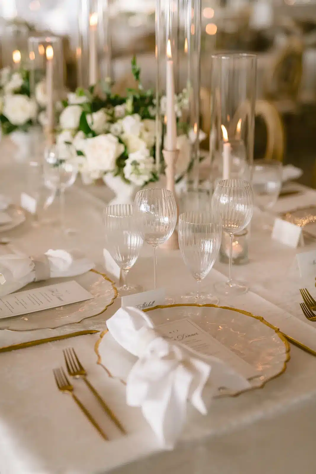 Elegant crystal chandelier glassware reflects candlelight on a refined wedding table, creating a luxurious and captivating atmosphere for guests. | Curated Events Elegant crystal chandelier glassware reflects candlelight on a refined wedding table, creating a luxurious and captivating atmosphere for guests.