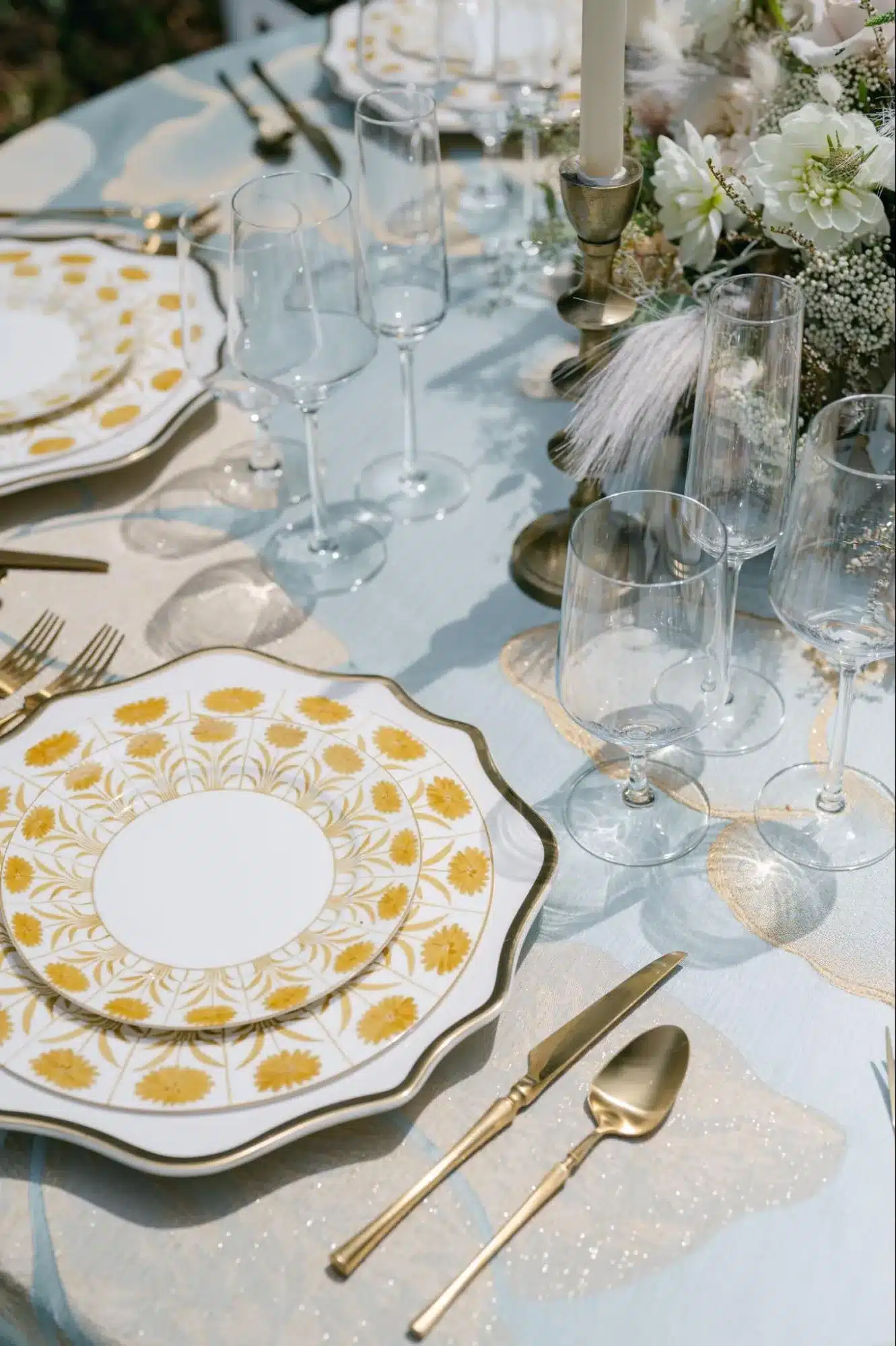 Sophisticated holiday table with gold-patterned china and crystal glassware