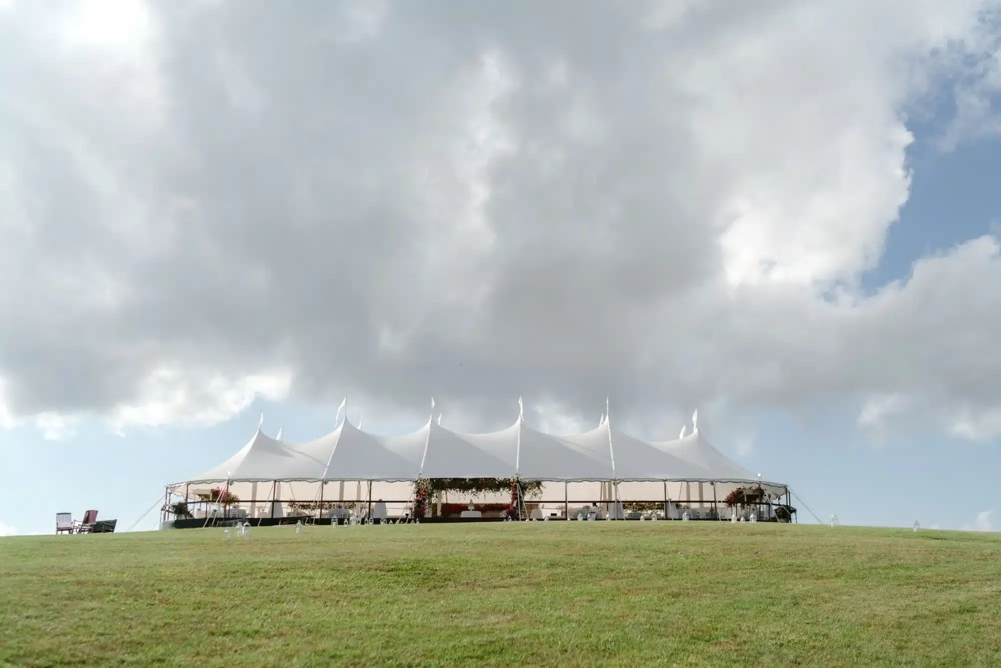 Grand white sailcloth tent on a hilltop, ready for a festive New Year’s Eve event in Raleigh.