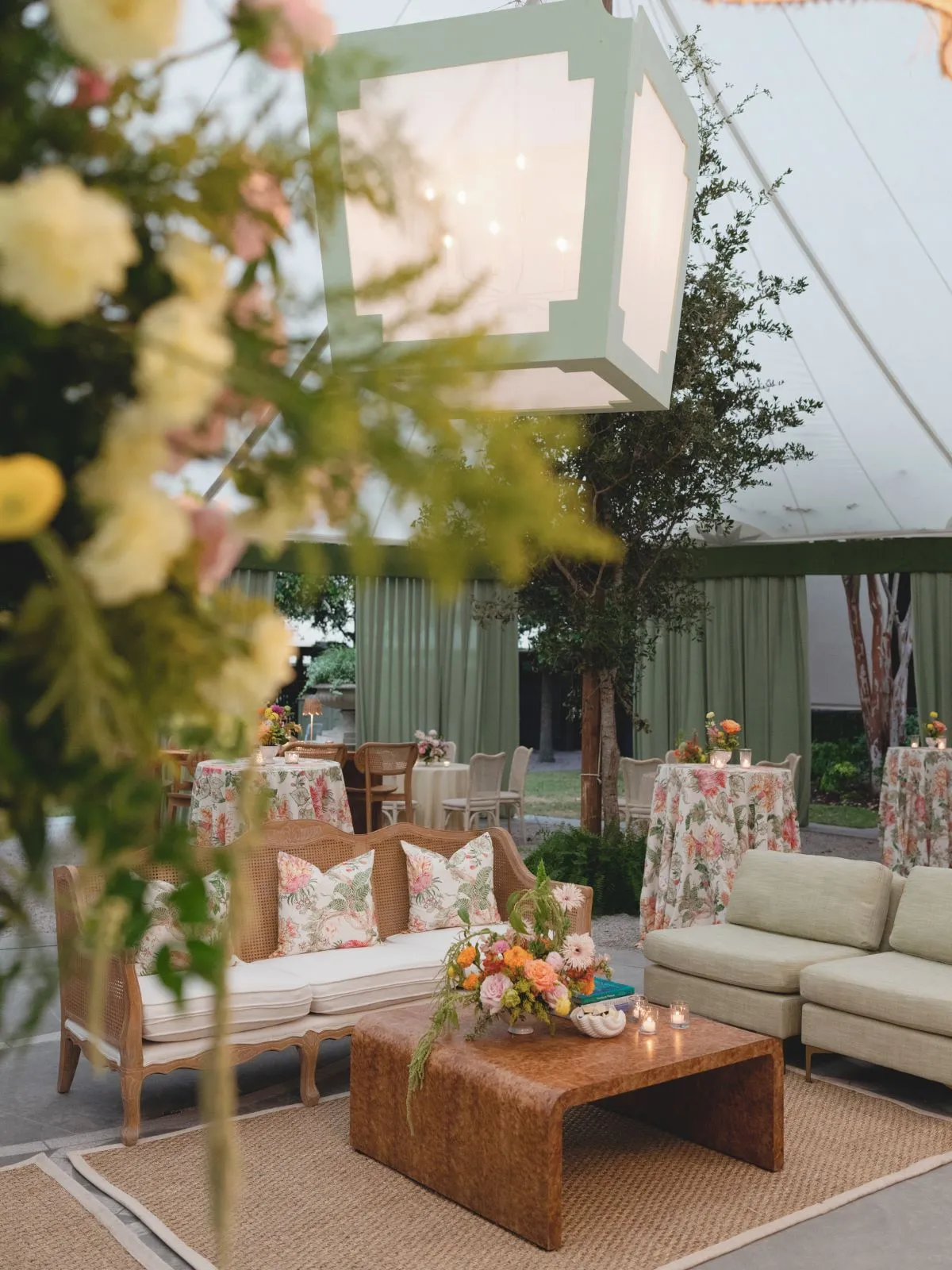 Luxury lounge area with floral sofas, wood coffee table, and soft ambient lighting.