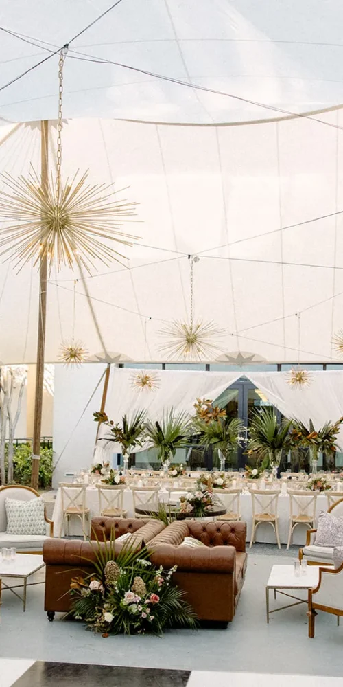 Pole tent interior with starburst lighting and lounge seating for reception