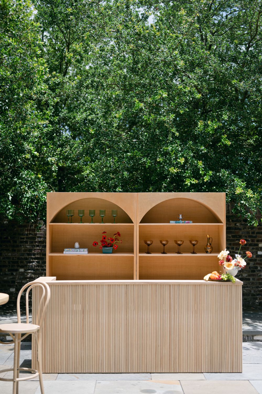 Outdoor wooden bar with arched shelving