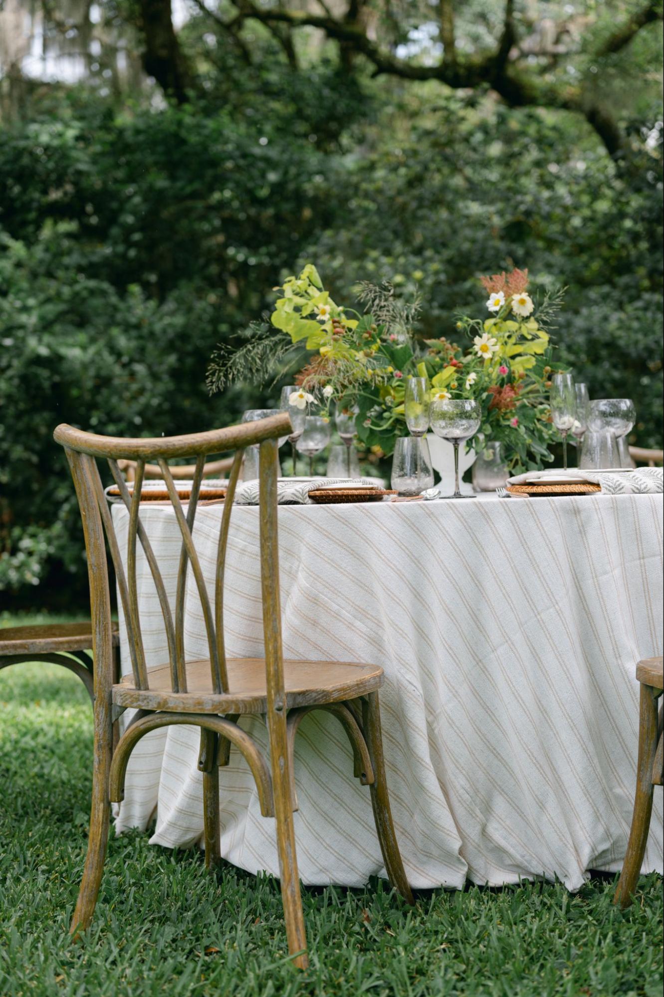 Outdoor table setting with striped linen and florals