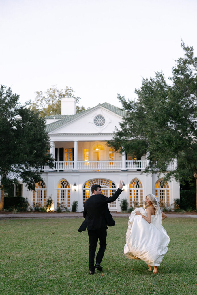 elegant wedding couple walking at estate venue