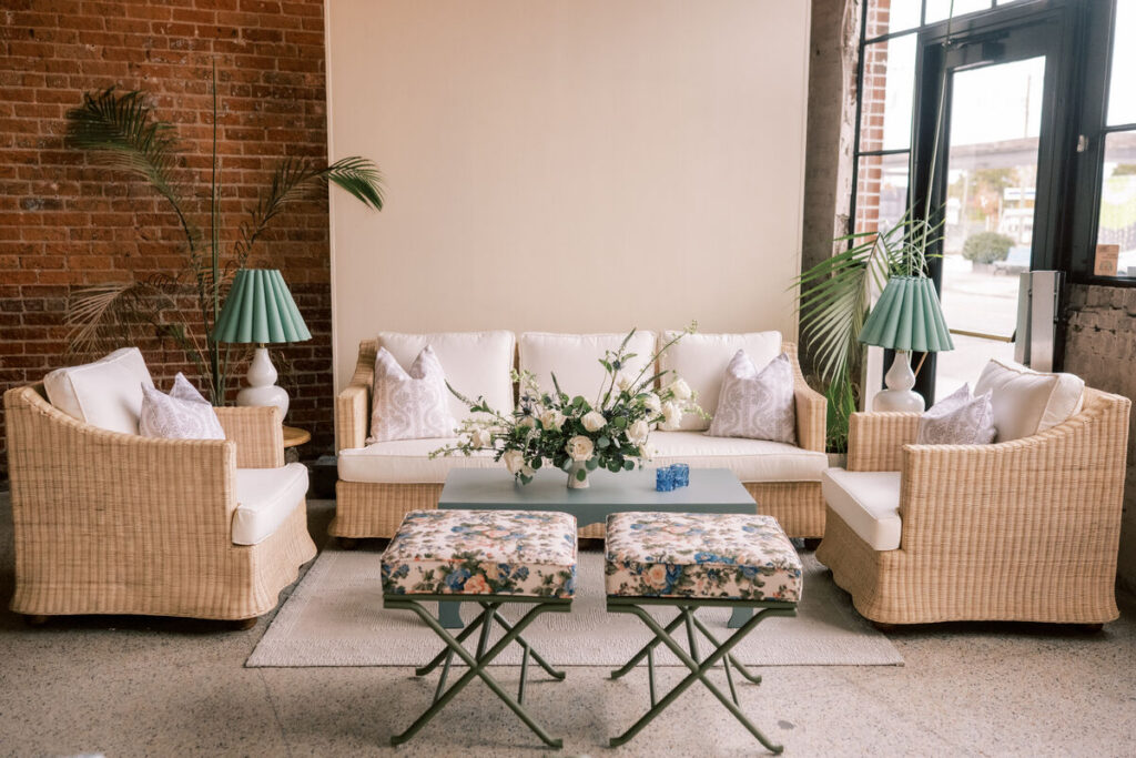 indoor event lounge seating wicker sofa greenery