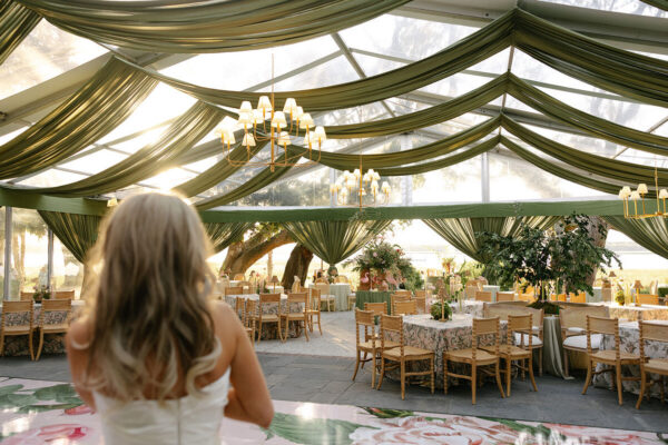 luxury wedding tent interior green drapery chandeliers