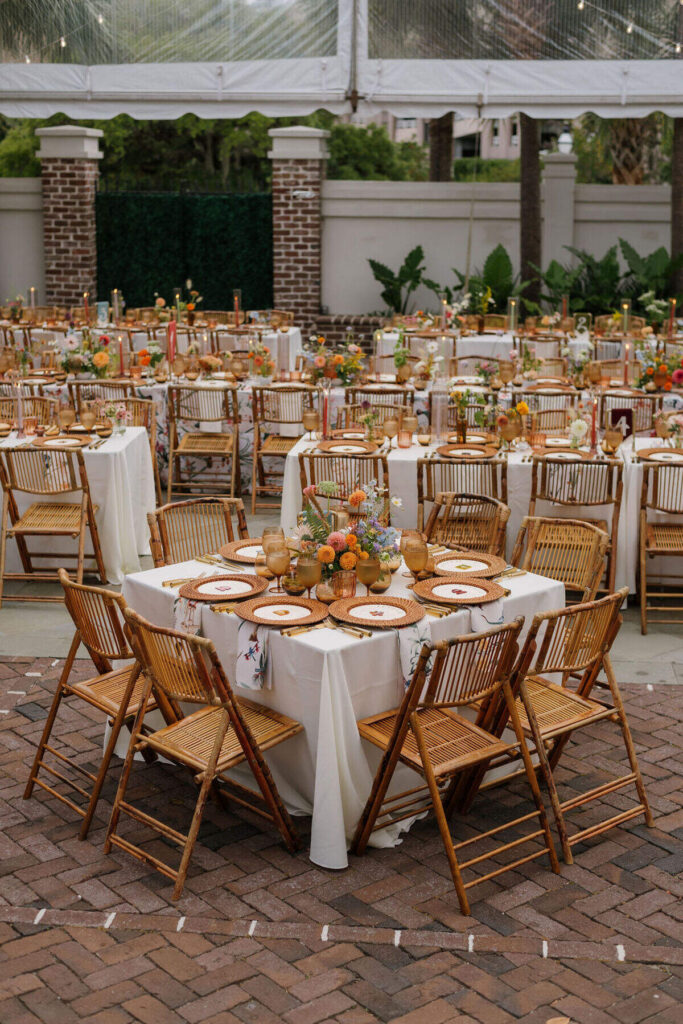 outdoor wedding reception with gold chiavari chairs and round tables