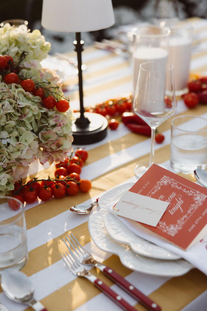 wedding tablescape with tomato decor and striped linens