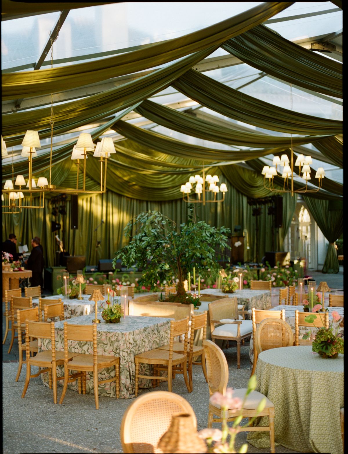 Chesapeake summer reception with green ceiling draping, chandeliers, rental chairs, and round dining tables | Curated Events Chesapeake summer reception with green ceiling draping, chandeliers, rental chairs, and round dining tables