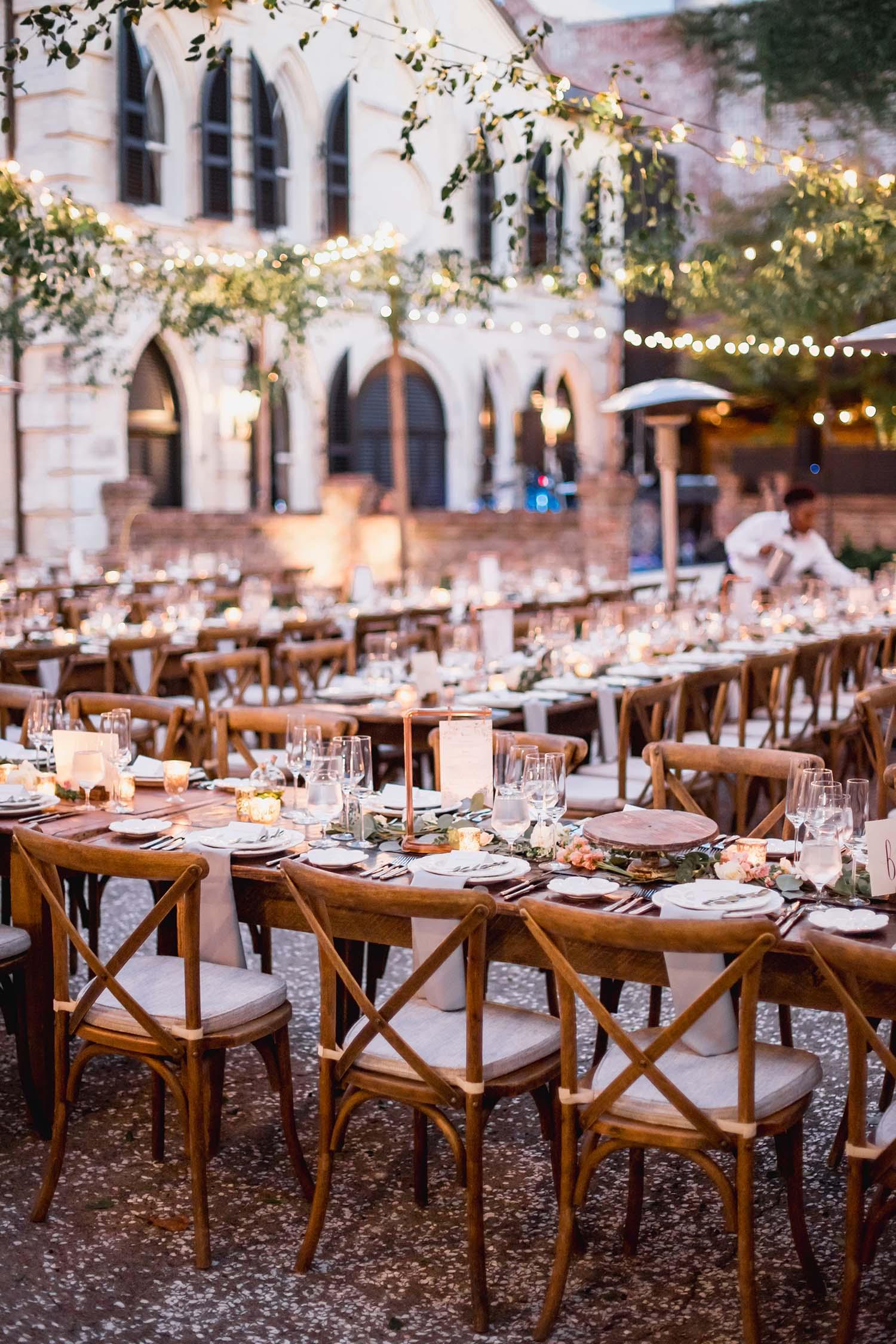 Outdoor lighting solutions including string lights, uplights, and lanterns for backyard events