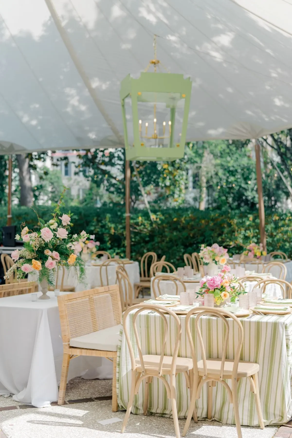 Charleston outdoor reception tables with green striped linens and colorful floral centerpieces