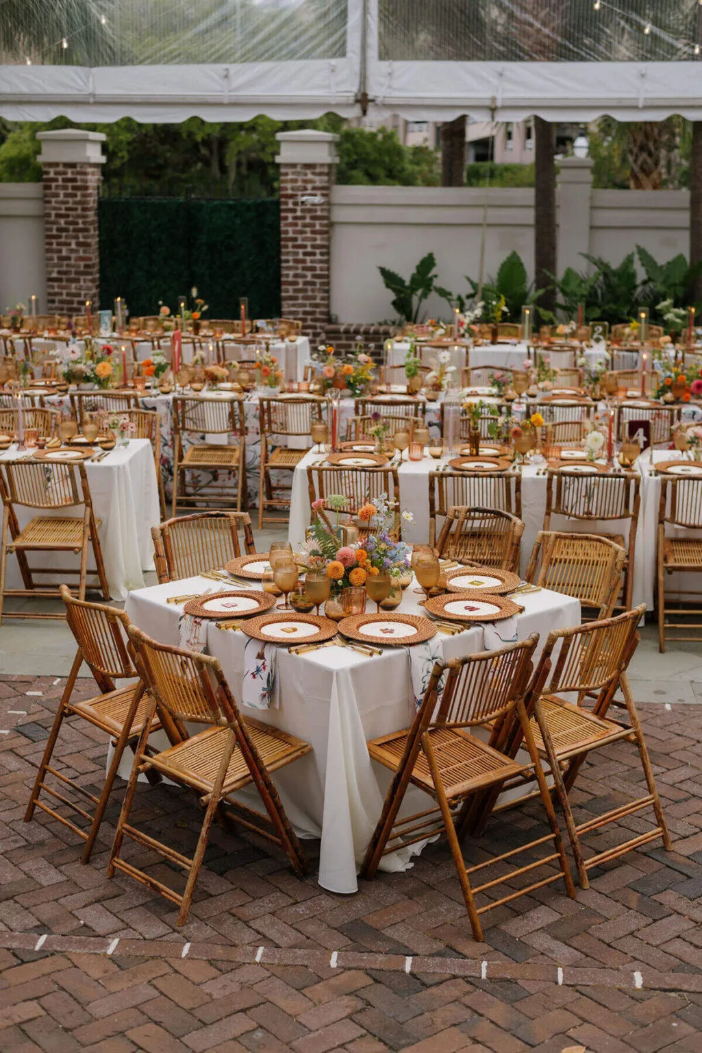 Tented wedding reception with draped ceiling, dining tables, and a central dance floor